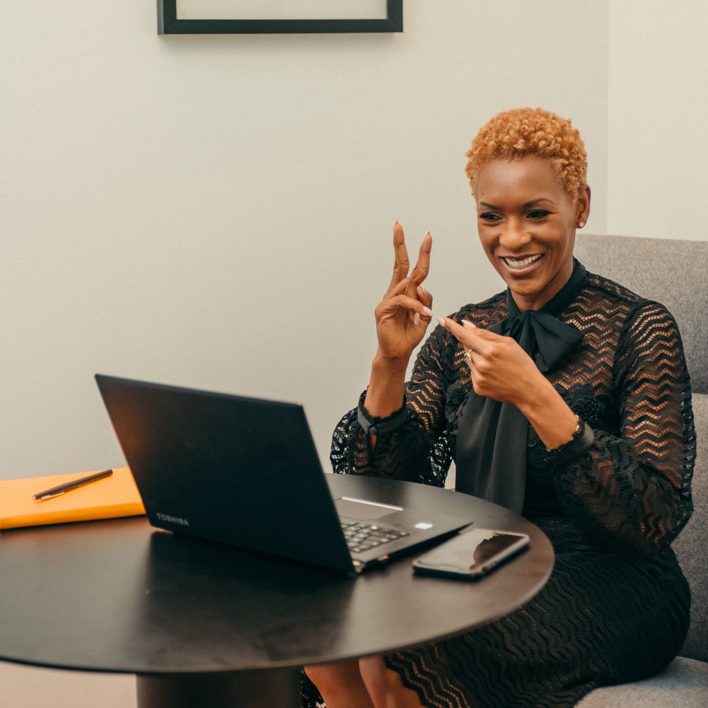 Woman using sign language during video teleconference