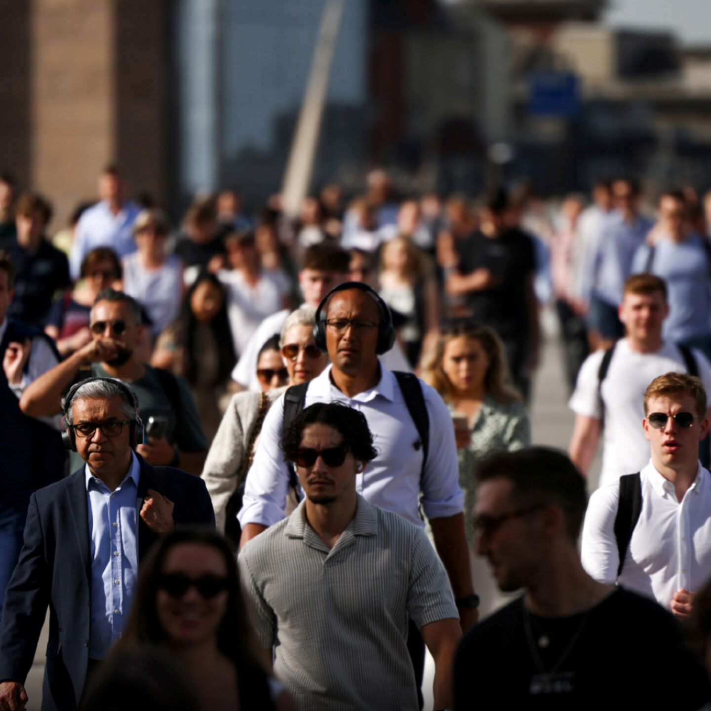 Group of people walking in a crowded sidewalk